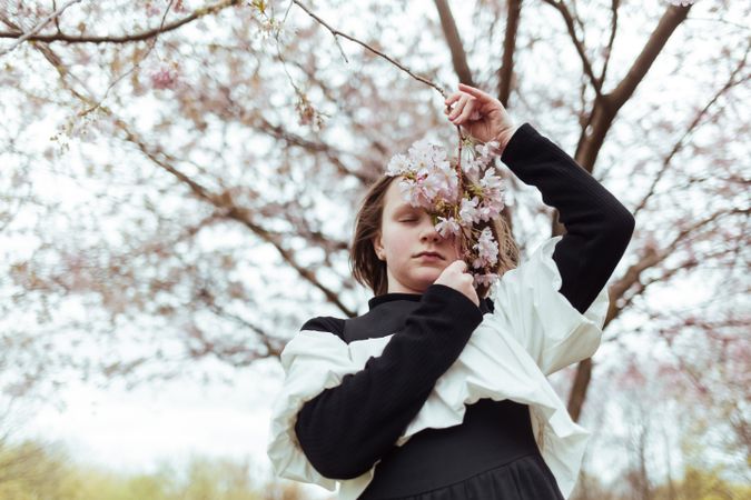 Girl with branch of blooming tree