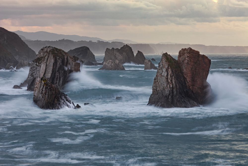 Storm with blustering waves on rocky coast