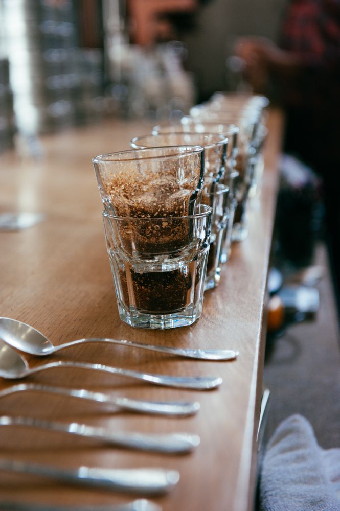 Close up oof stacked glasses for coffee tasting with spoons in foreground