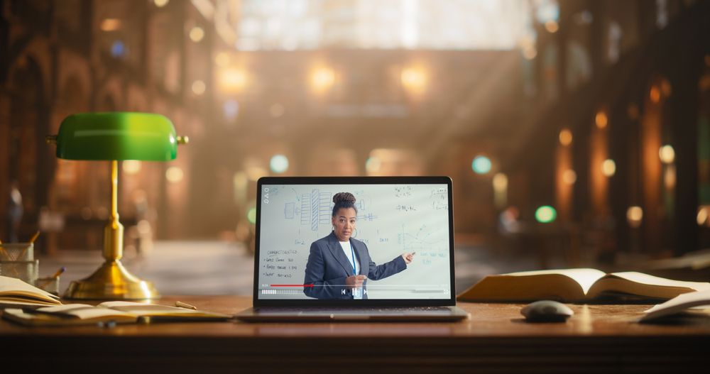 Engaging Online Presentation by a Professional Black Female on a Laptop Screen, Set in a Classic Library Environment.