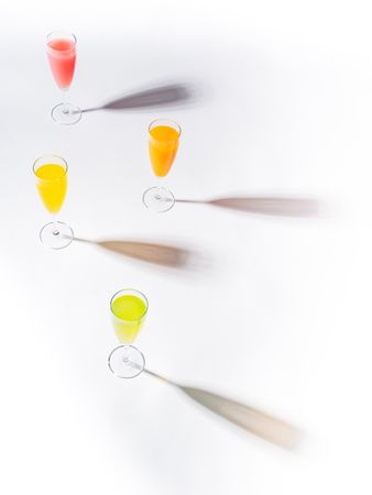 Glasses of bright colorful drinks on table