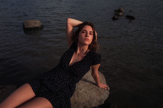 Sensual woman resting on lake shore