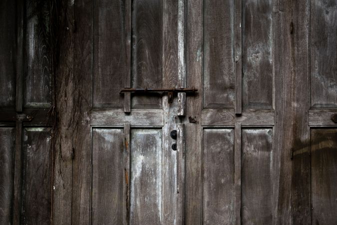 Big old broken wooden door on brick wall of historical building located in Kota Lama, Semarang City, Indonesia.