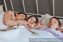 Mother sleeping with young son and daughter 5R9vB0