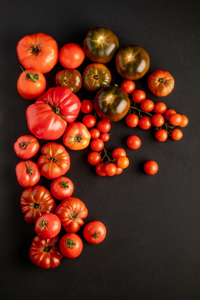 from above view of tomatoes on a dark surface