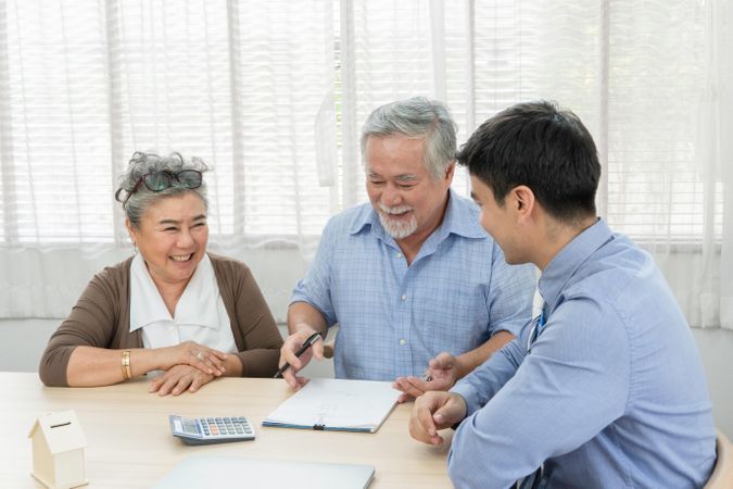 Asian man signing on agreement contract with with and businessman