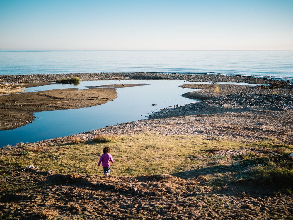 small girl walking by the beach