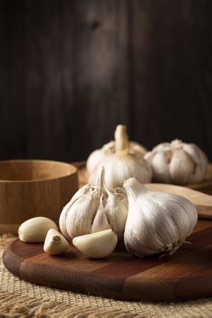 Garlic bulb and garlic cloves on the wooden table.