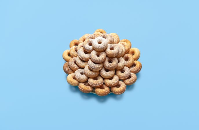 Doughnuts on a plate, isolated on a blue table