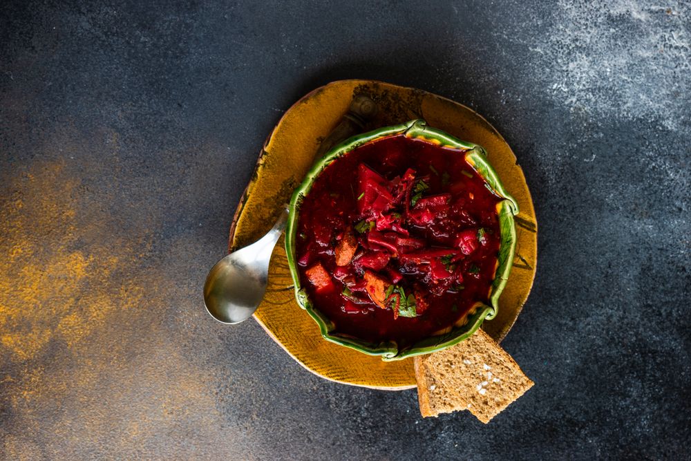 Ukrainian beetroot soup borscht in green bowl
