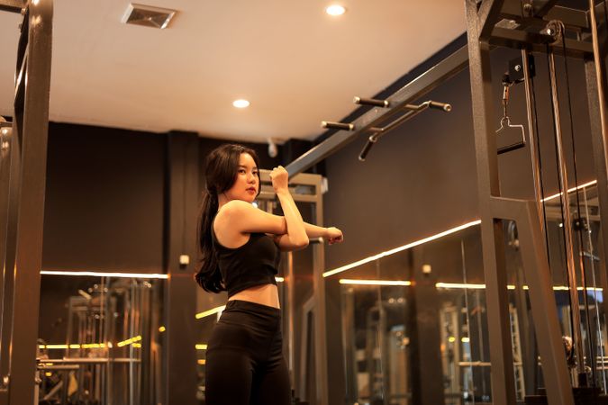 Young Woman Stretching Hand in the Gym