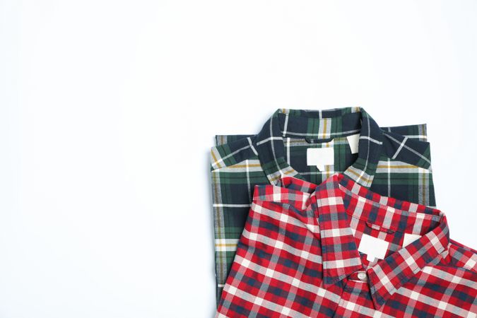Different beautiful shirts on plain background, copy space