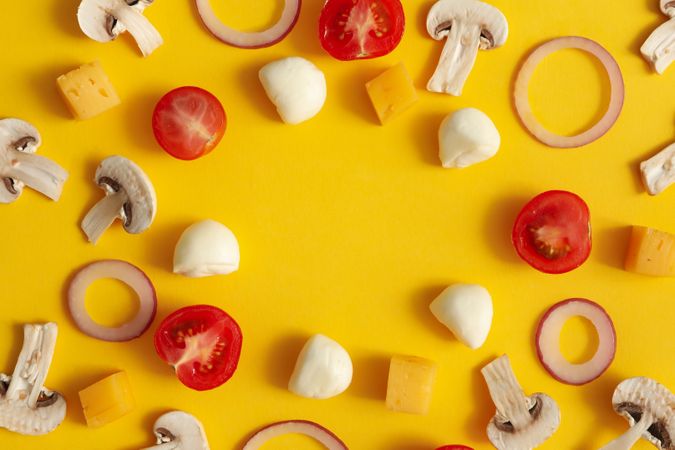 Ingredients for cooking pizza on yellow background