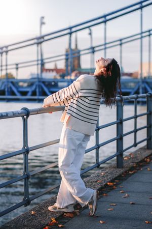 Young woman in trendy summer  clothes on the waterfront