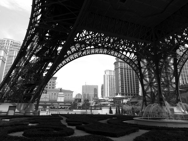 Grayscale photo of lower part of Eifel tower in Paris, France
