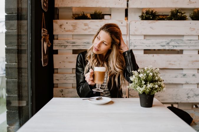 Woman drinking coffee from a glass