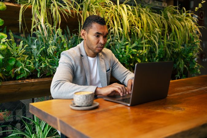 Man working on laptop at cafeteria