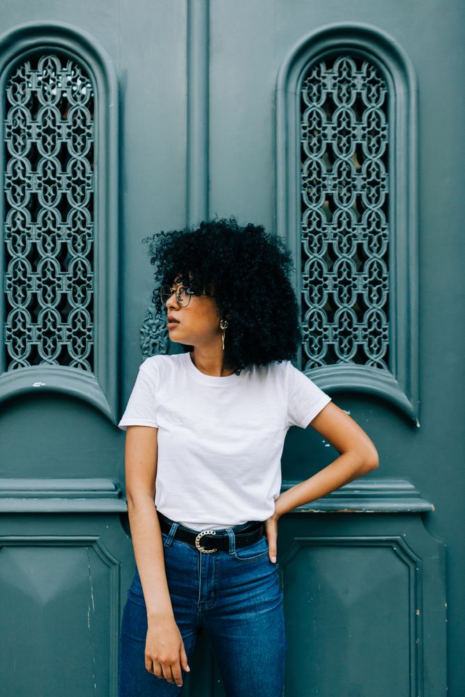 Stylish Black female by green door