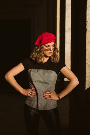 Stylish female standing near building wall