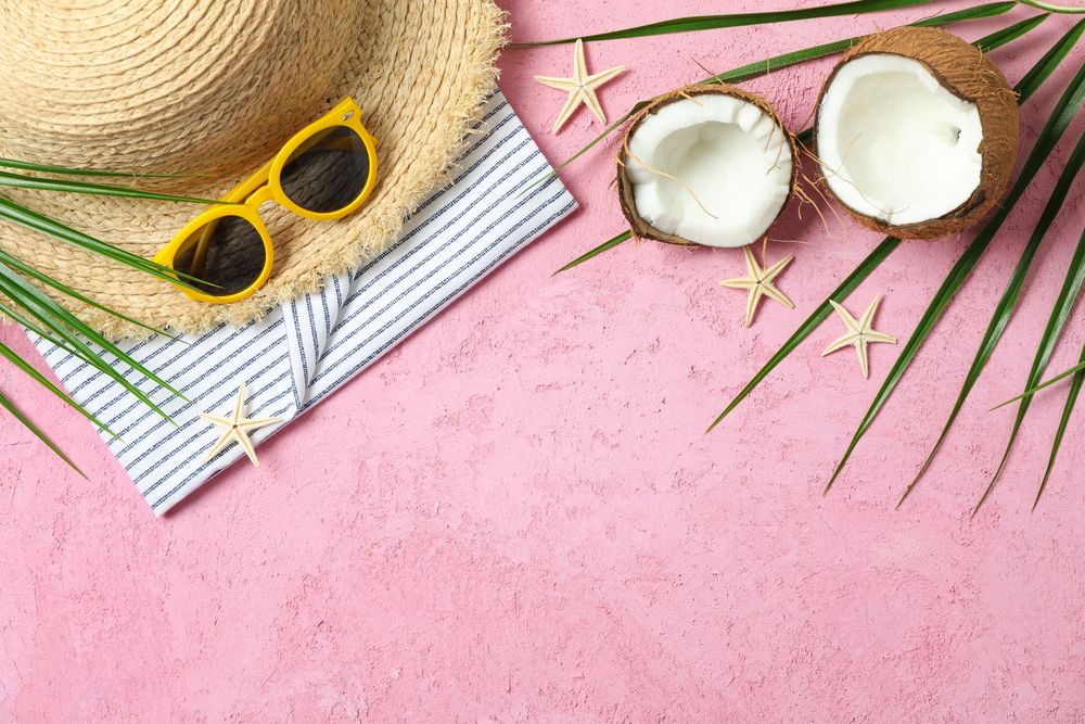 Summer vacation accessories on color background, space for text. Summer vacation backdrop