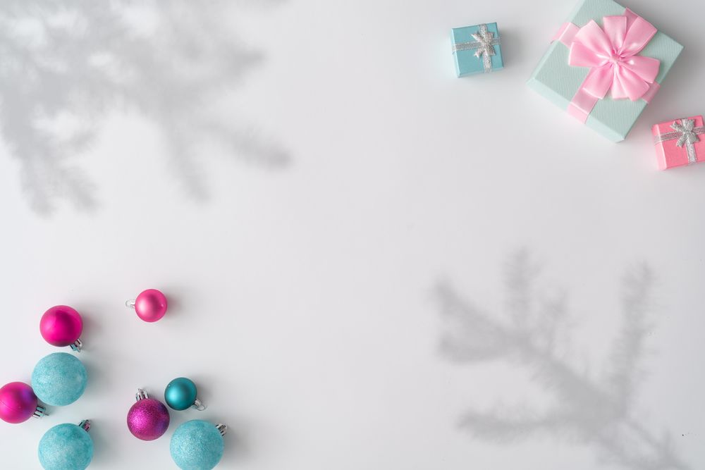 Christmas decorations, gifts with shadows on corners of light background
