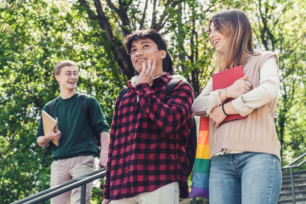 University students hanging out talking on outdoor stairs