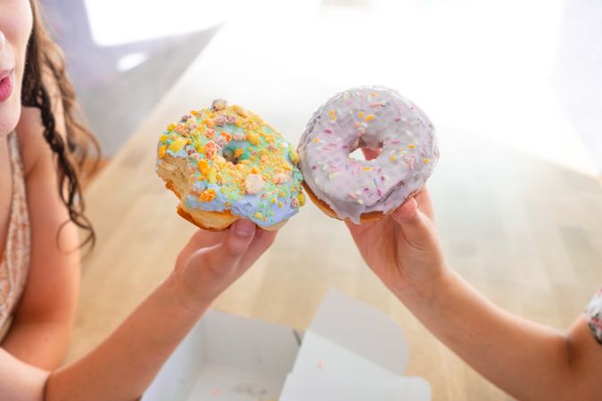 Women enjoying decorated donuts