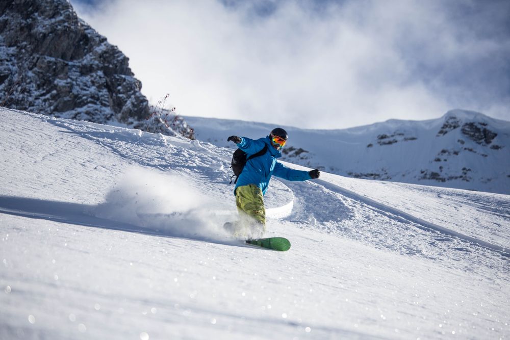 Person snowboarding during daytime