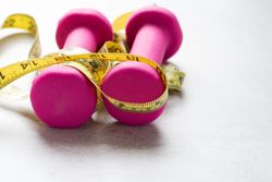 Dumbbells and Measuring Tape Fitness-Inspired Healthy Living