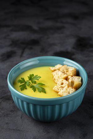 Bowl with onion soup and croutons on the table.