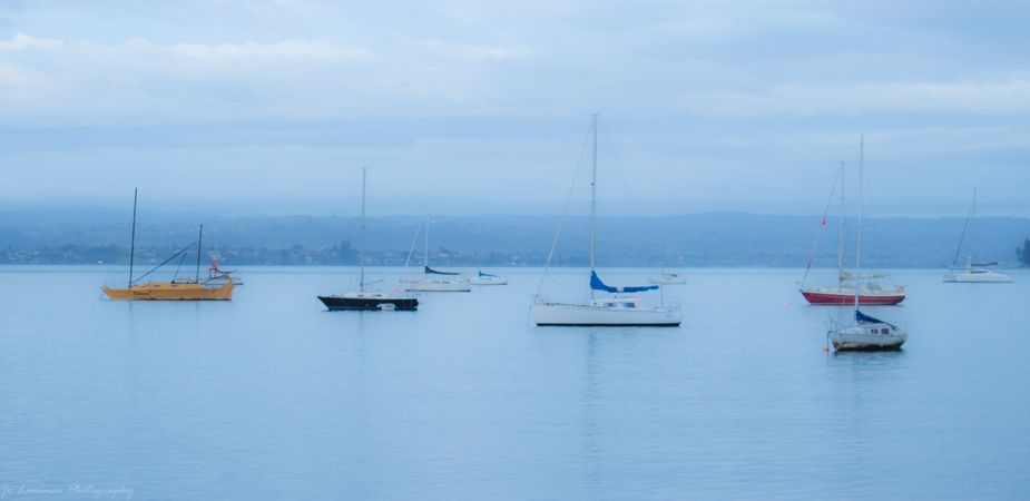 Boats in sea under blue sky