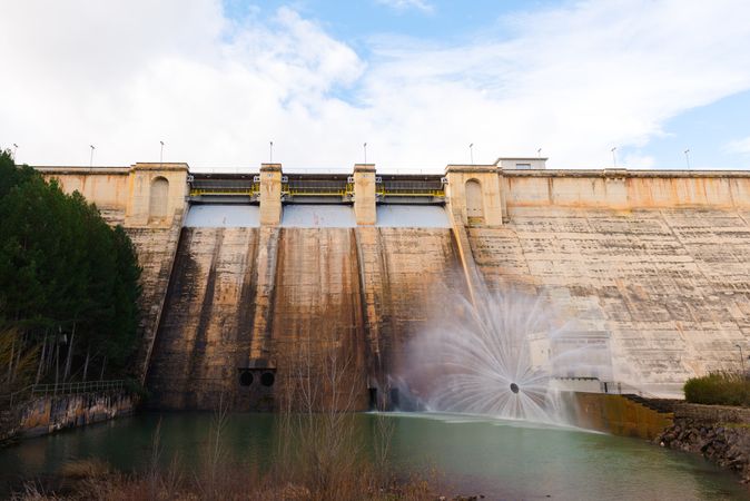 Concrete hydroelectric power station in sunlight