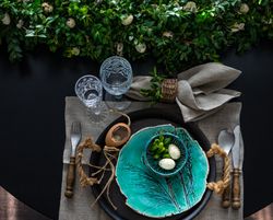 Top view of Easter table setting with decorative teal plate