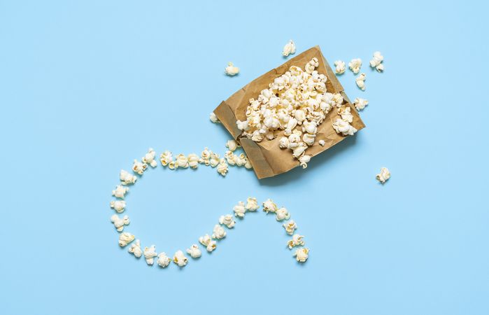 Popcorn in a paper bag isolated on blue background