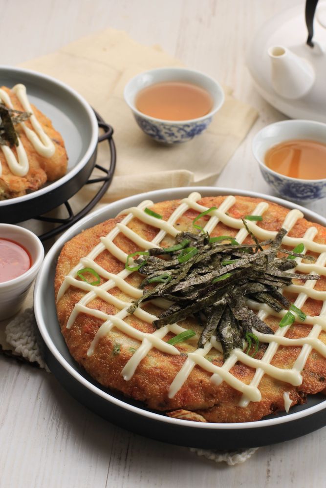 Japanase Okonomiyaki, Served on Ceramic Plate with Tea