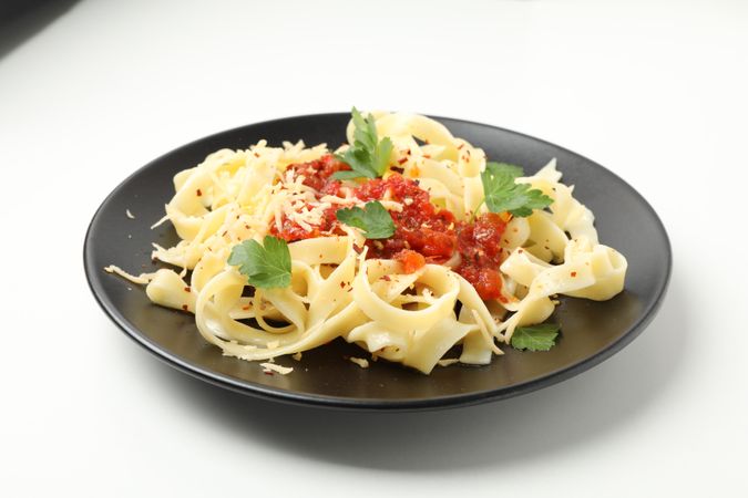 Plate with tasty pasta isolated on plain background