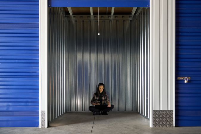 Nice woman closing or opening storage storage room for moving