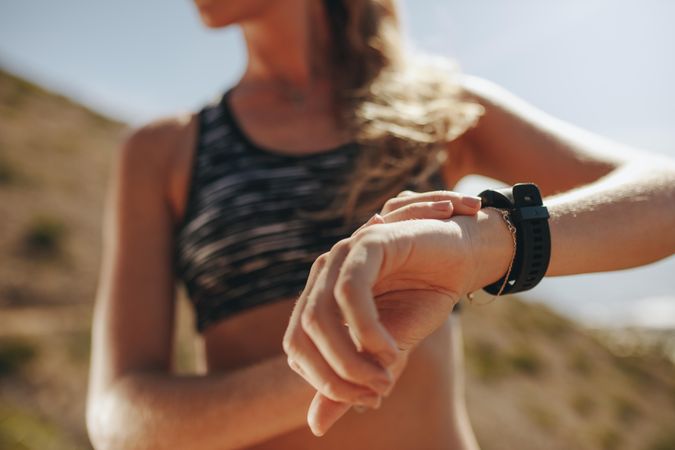 Female runner checking fitness progress on her smart watch