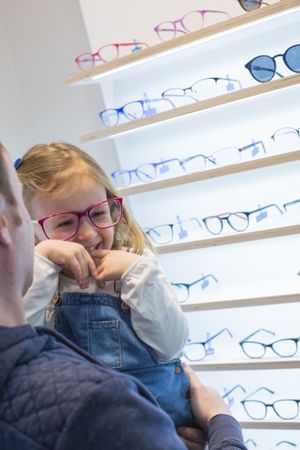 Young girl trying on glasses