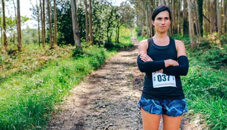 Female trail athlete posing with race number