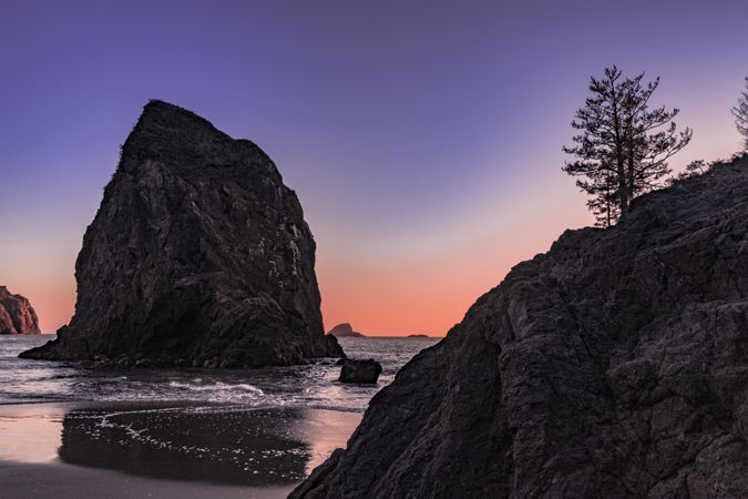 Rocks on the coast at sunset with beautiful purple orange sky