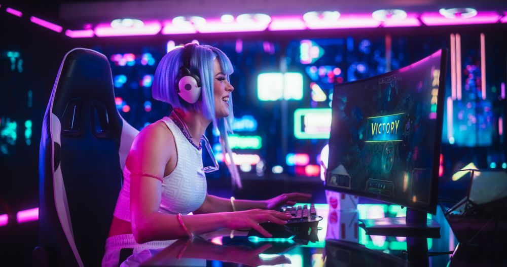 Female Online Gamer Playing a Strategy Video Game in a Futuristic Cyberpunk Room.
