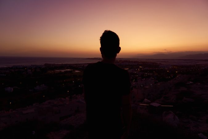 Silhouette of male enjoying picturesque sunset