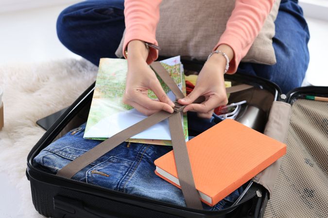 Female Young Woman Packing Suitcase for Vacation