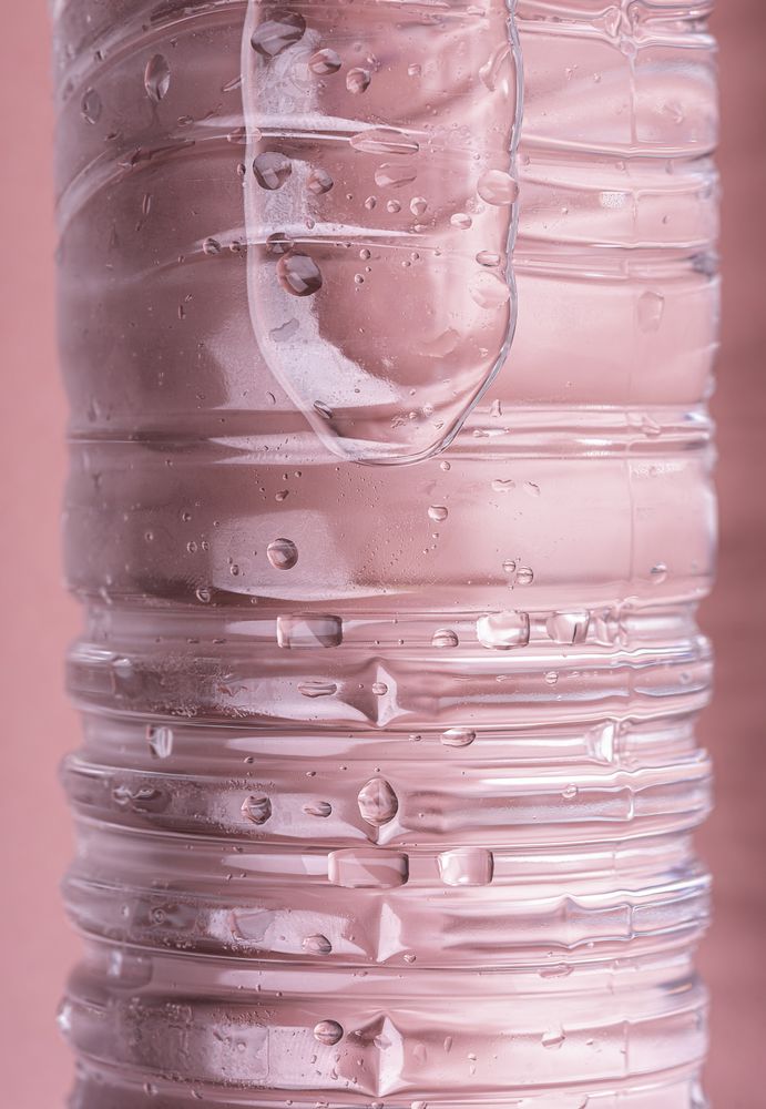 Water bottle on pink background close-up
