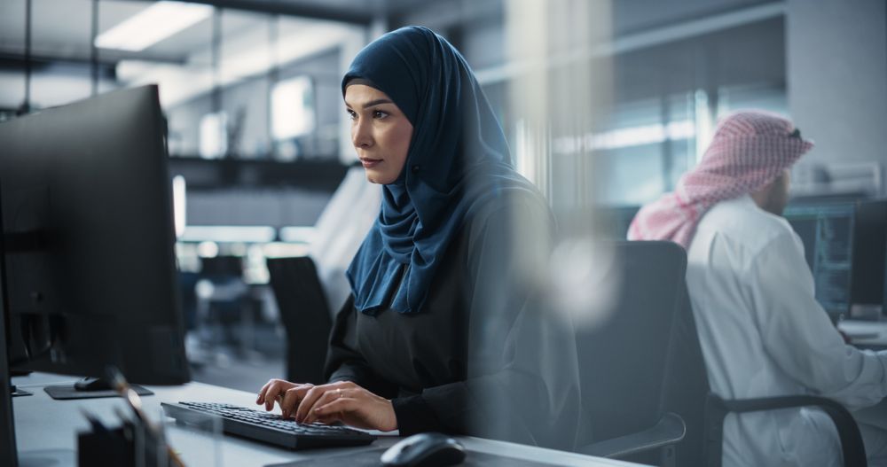 Portrait of a Smart Focused Middle Eastern Engineer Working on Computer in a Technological Corporate Office.