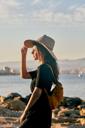 Woman traveler in straw hat walking