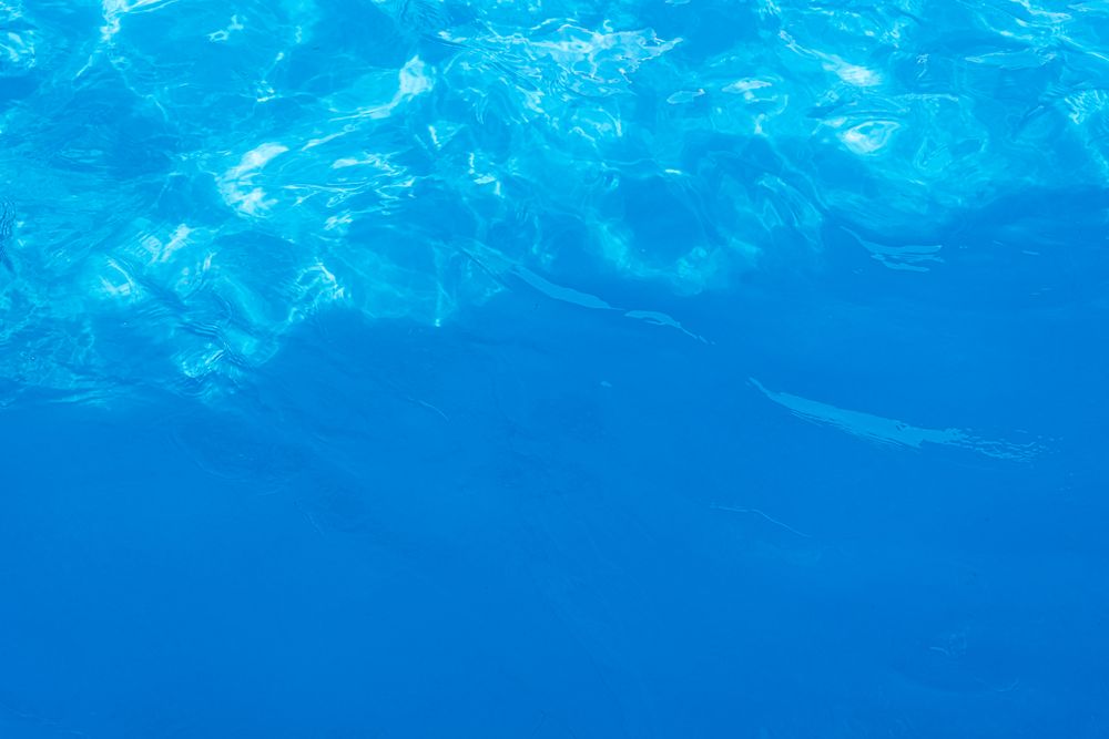Blue water in the pool in sunny summer day