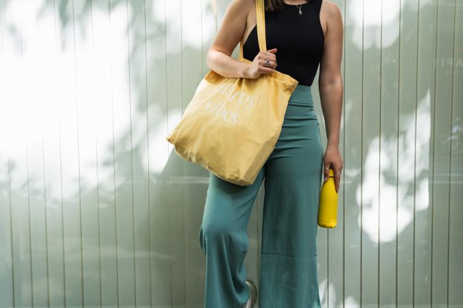 Crop woman with eco friendly bag in city