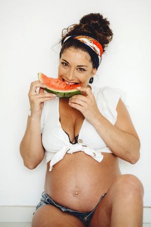 Pregnant female eating delicious watermelon